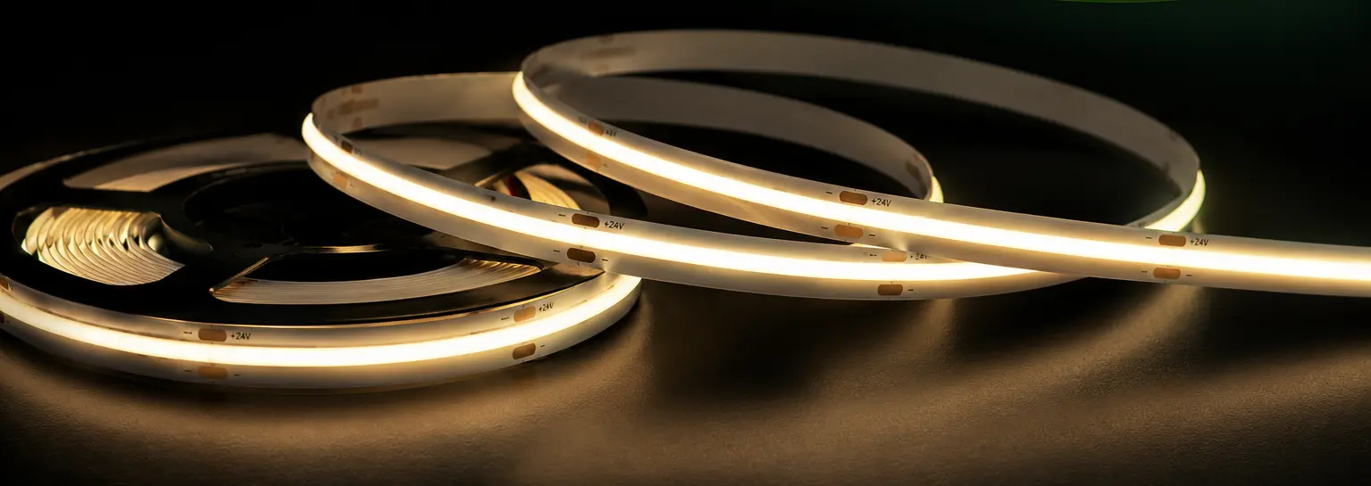 Warm white LED strip lighting glowing on the reel